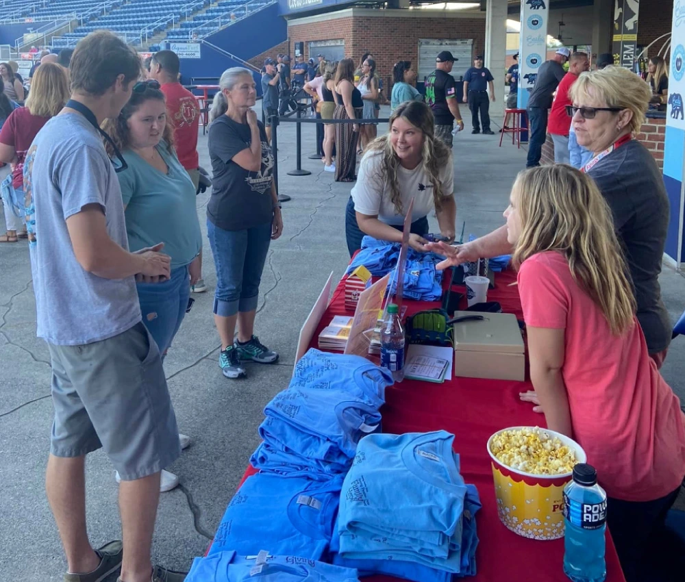 volunteers at an event working to spread information for the Ronald McDonald house