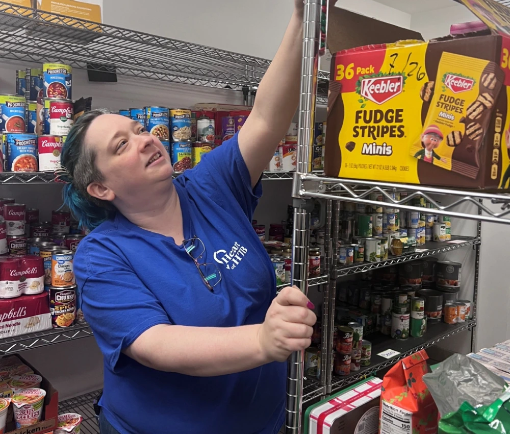 volunteer organizing a dry pantry