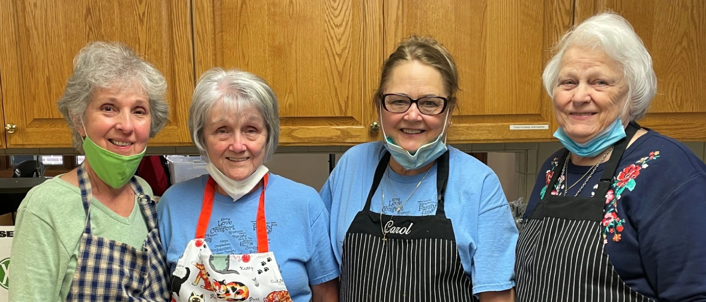 group of volunteers preparing dinner for our guests