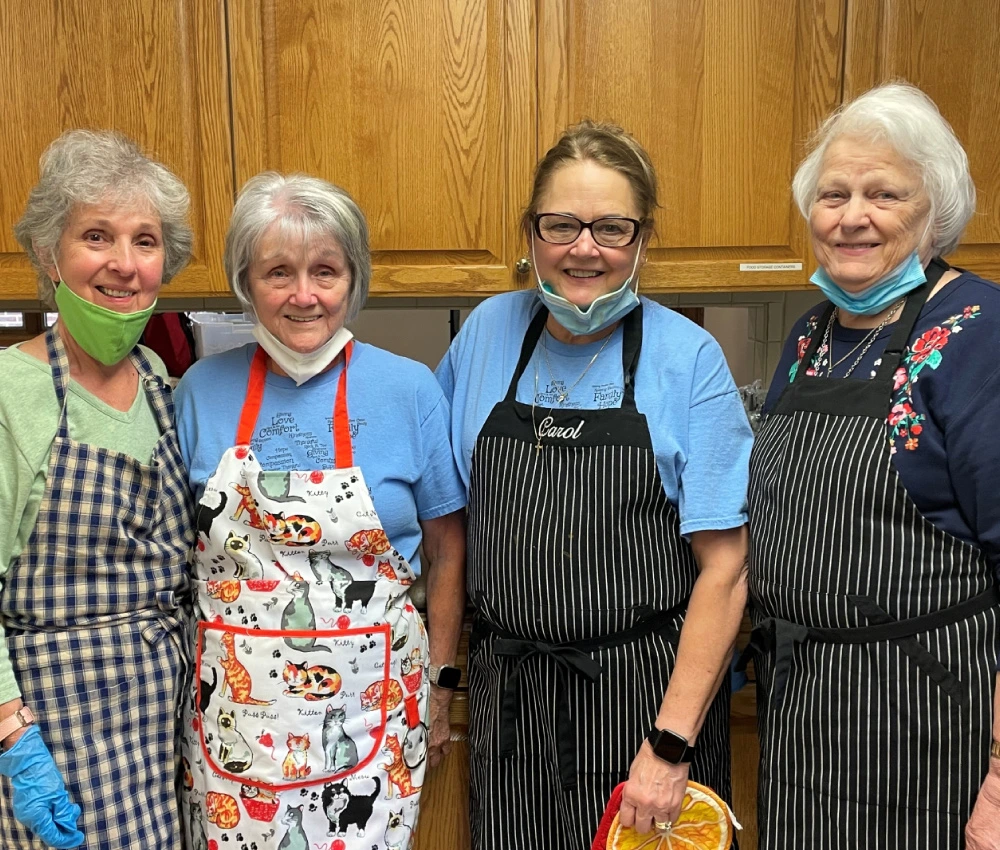 group of volunteers preparing dinner for our guests