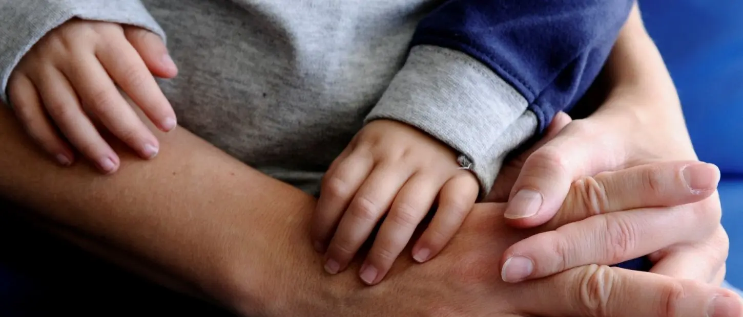 adult with a Childs' hands in theirs