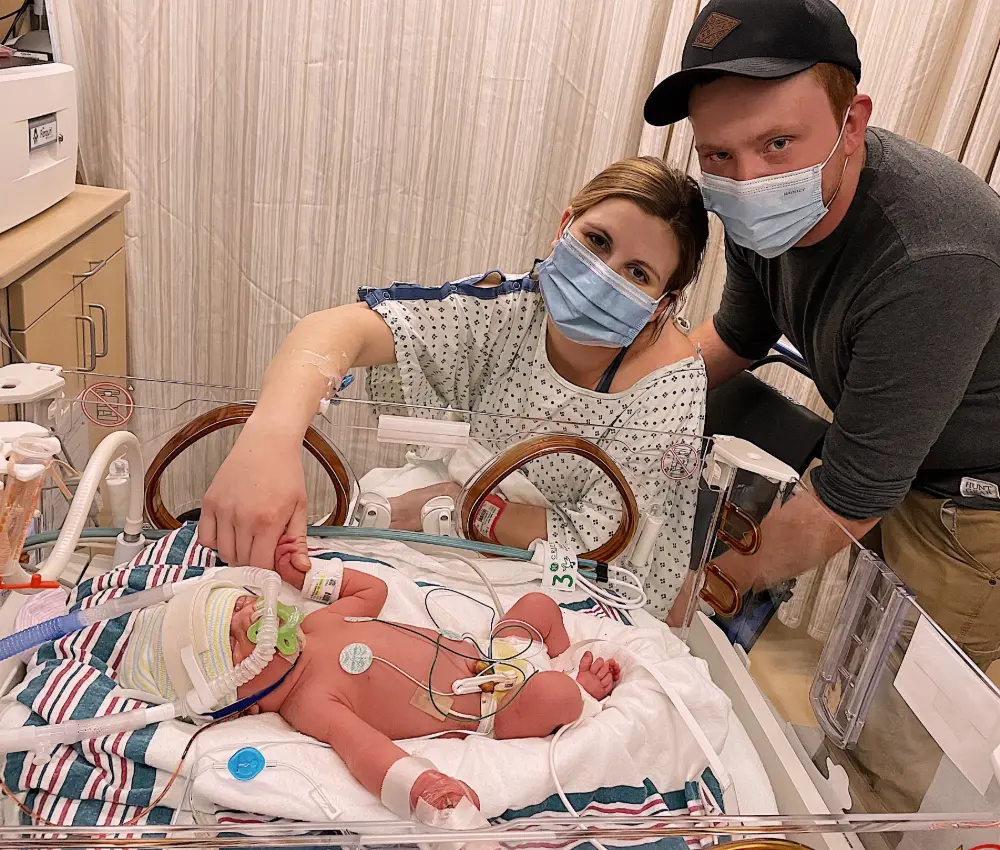 mother and father with newborn in hospital room