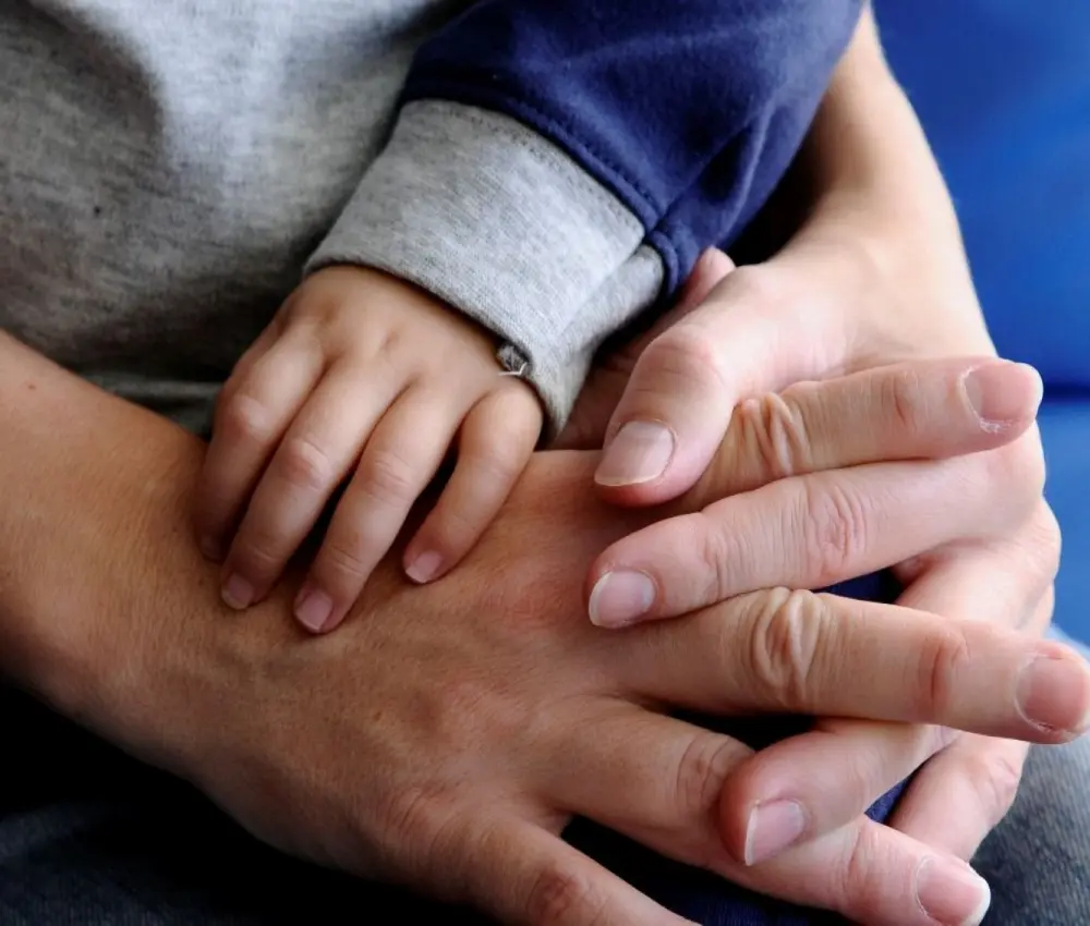 adults hands with a Childs' hands in theirs